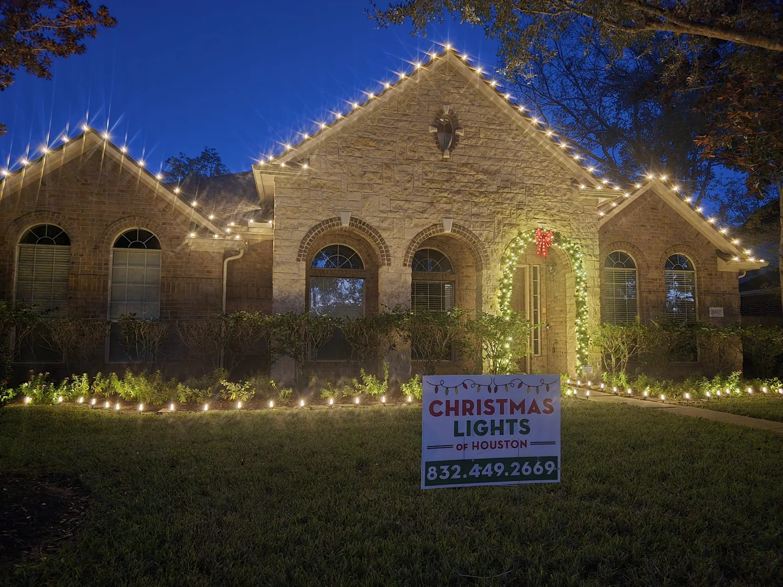 Christmas Lights of Houston installers completing a holiday lighting setup on a Houston home